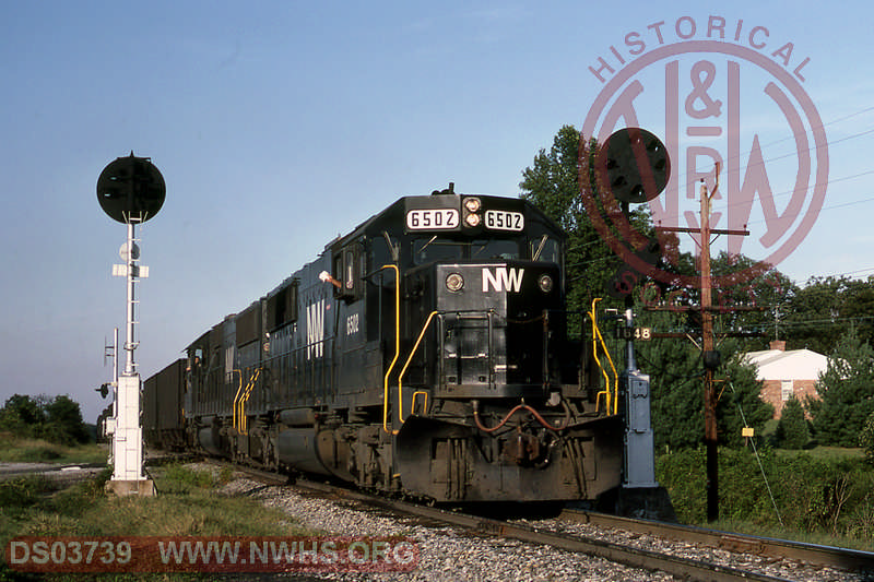 Norfolk and Western EMD SD50S 6502 leads another EMD- westbound hoppers at Elam, VA