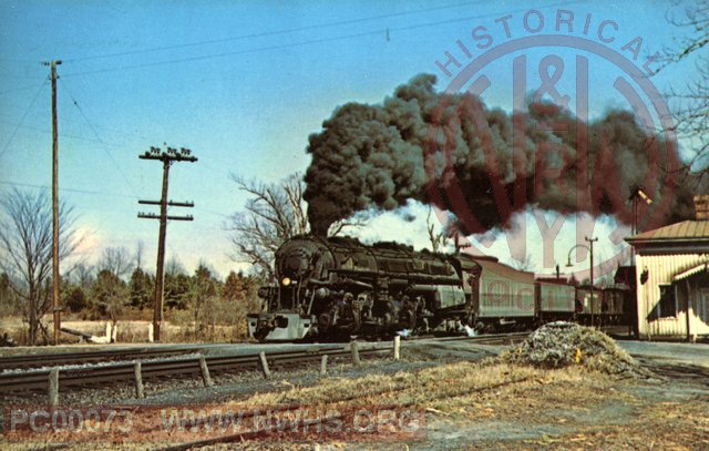 A Norfolk and Western Class A 2-6-6-4 simple articulated locomotive stomrs through Ford, Virginia with a train of hopper cars on March 4, 1959