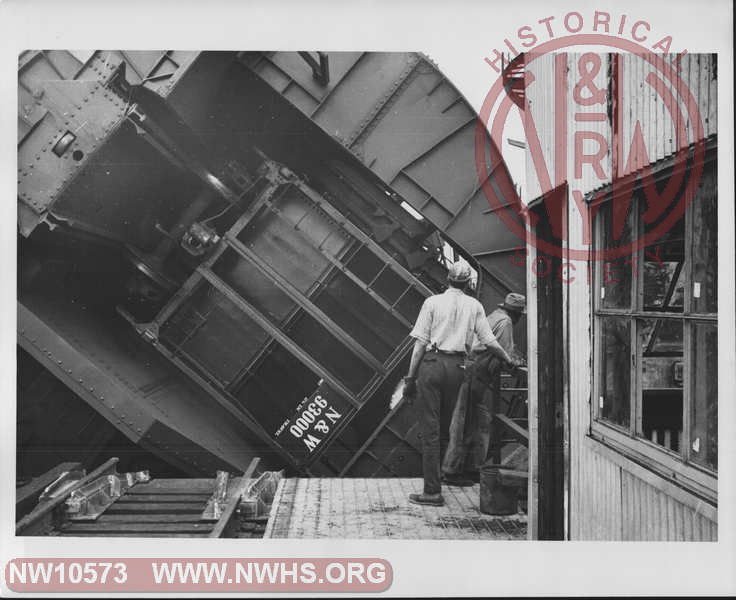 Closeup view of Class H-13 Hopper 93000 (A End visible) rotated (fully?) in car dumper on one of the Lambert's Point Coal Piers