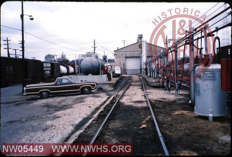 Locomotive fuel rack at Huntingburg with shop in background